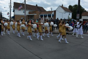 Padua Franciscan High School cheerleaders with pom poms walking in a parade in Parma, OH