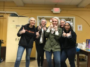 5 Padua Franciscan High School girls posing with thumbs ups on a field trip