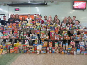 Padua Franciscan High School students and staff in front of collected food items