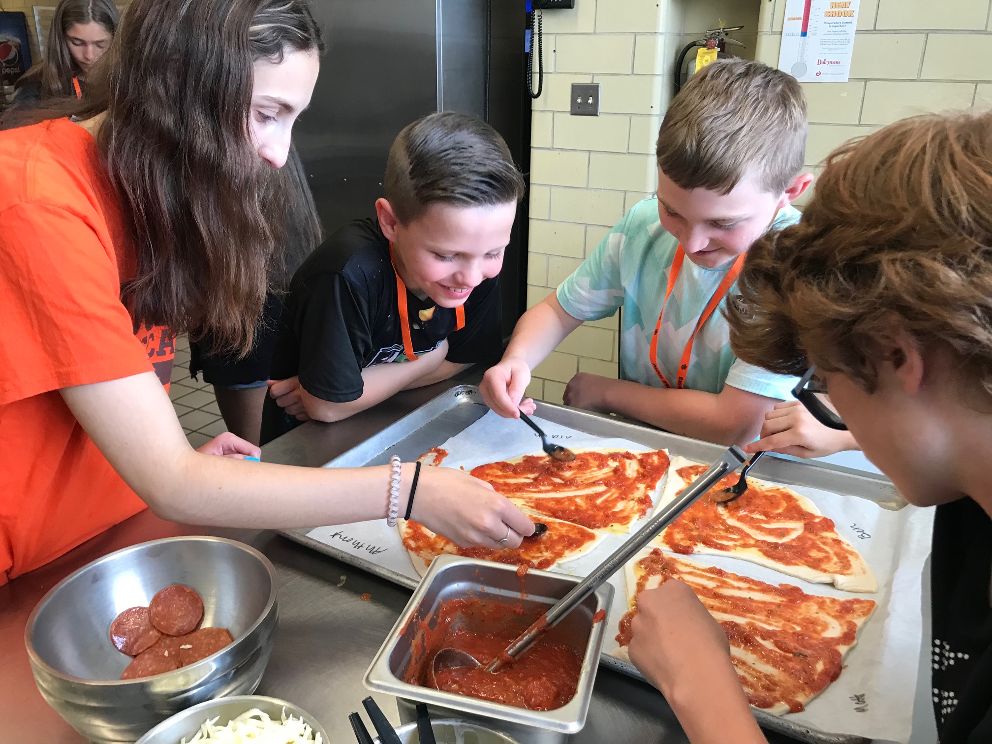 Padua Franciscan students making a pizza