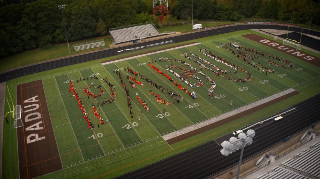Padua Franciscan High School students spelling out "PADUA" on the football field